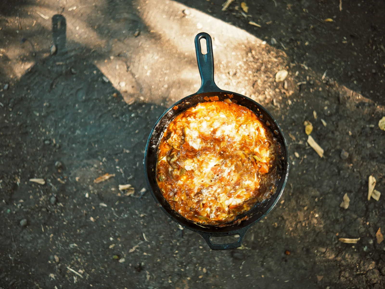 Food in a cast-iron skillet outdoors